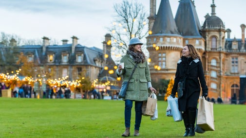 Visitors exploring the Christmas market at Waddesdon Manor, Buckinghamshire